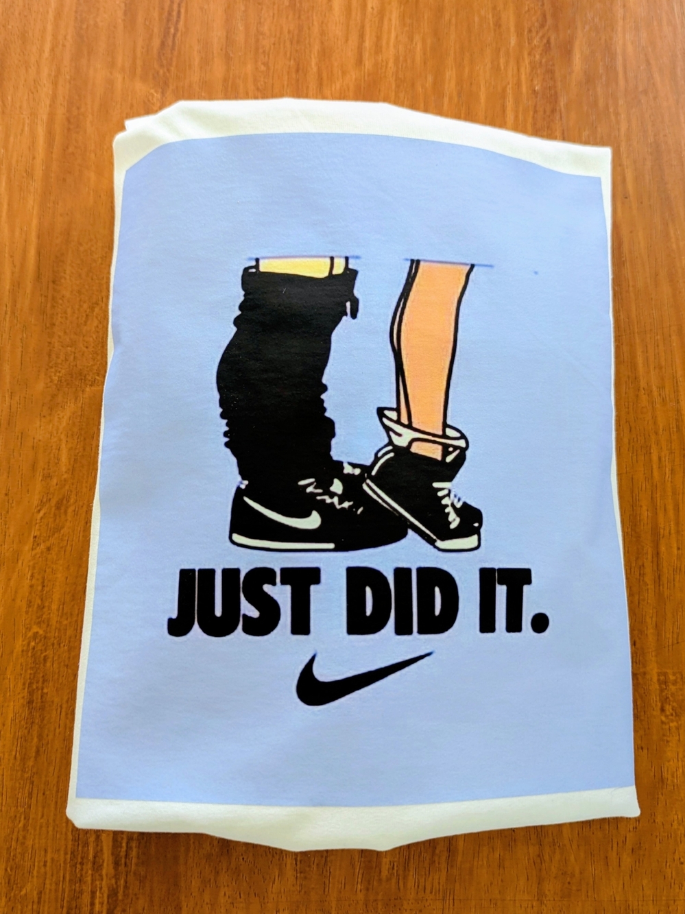 Nike Light Blue Graphic Tee with Black Illustration